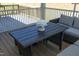 Close up of the screened in patio with comfortable seating and a decorative centerpiece on a table at 609 Ramsours Mill Dr, Holly Springs, NC 27540