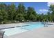 Community pool surrounded by lush greenery and lounge chairs for relaxation at 609 Ramsours Mill Dr, Holly Springs, NC 27540
