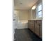 Elegant bathroom with double sink vanity, modern fixtures, and a tub with subway tile surround at 61 Black Walnut Dr # 188, Garner, NC 27529