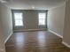 Bright bedroom with hardwood floors, neutral walls, and two windows offering natural light at 61 Black Walnut Dr # 188, Garner, NC 27529