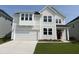Charming two-story home with white siding, a red front door, and an attached two-car garage at 61 Black Walnut Dr # 188, Garner, NC 27529