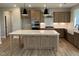 Modern kitchen with quartz countertops, a large center island, stainless steel appliances, and a farmhouse sink at 61 Black Walnut Dr # 188, Garner, NC 27529