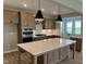 Modern kitchen with quartz countertops, a large center island, stainless steel appliances, and a farmhouse sink at 61 Black Walnut Dr # 188, Garner, NC 27529
