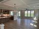 Open-concept living room with coffered ceilings, a ceiling fan, and large windows offering ample natural light at 61 Black Walnut Dr # 188, Garner, NC 27529