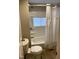 Bathroom with a shower and bathtub combination and neutral color scheme at 701 Linwood Ave Ave, Durham, NC 27701