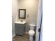 Bathroom with gray vanity, updated fixtures, and toilet at 701 Linwood Ave Ave, Durham, NC 27701