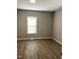 Neutral bedroom featuring gray walls and wood flooring at 701 Linwood Ave Ave, Durham, NC 27701