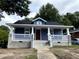 Charming blue home featuring a cozy front porch with white columns and railings at 701 Linwood Ave Ave, Durham, NC 27701
