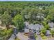 Overhead shot of an expansive property surrounded by a canopy of vibrant green trees at 7601 Wellesley N Park, Raleigh, NC 27615