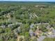 Aerial view of homes nestled in mature trees and green landscape at 7601 Wellesley N Park, Raleigh, NC 27615