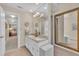 This bathroom features double vanity with granite countertop, large framed mirror, and stool at 7601 Wellesley N Park, Raleigh, NC 27615