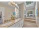 Bright bathroom features a double vanity with granite countertops and a large soaking tub with a skylight at 7601 Wellesley N Park, Raleigh, NC 27615