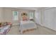 Cozy bedroom featuring two windows with white shutters and a quaint floral sofa at 7601 Wellesley N Park, Raleigh, NC 27615