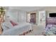 Bright bedroom with white closets and large dresser displaying TV at 7601 Wellesley N Park, Raleigh, NC 27615