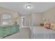 Bright bedroom featuring vintage green dresser, four poster bed and neutral paint color at 7601 Wellesley N Park, Raleigh, NC 27615