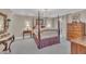 Spacious bedroom with a four-poster bed, chandelier, and access to an outdoor area at 7601 Wellesley N Park, Raleigh, NC 27615