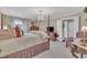 Inviting bedroom with a four-poster bed, chandelier, and classic furnishings at 7601 Wellesley N Park, Raleigh, NC 27615