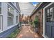 Charming courtyard with brick patio, seating area, and access to the house at 7601 Wellesley N Park, Raleigh, NC 27615