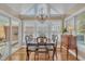 The naturally-lit dining area features a chandelier, hardwood floors, and large windows at 7601 Wellesley N Park, Raleigh, NC 27615