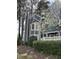 Charming home exterior showcasing blue siding, white trim, and mature trees at 7601 Wellesley N Park, Raleigh, NC 27615