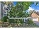 A charming home exterior with blue siding, a brick garage, and manicured landscaping, creating curb appeal at 7601 Wellesley N Park, Raleigh, NC 27615