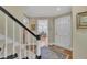 Welcoming home foyer with staircase, hardwood floors, and view to the dining room at 7601 Wellesley N Park, Raleigh, NC 27615