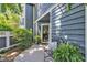 Charming front entrance with a wooden bench, potted plants, and stylish exterior at 7601 Wellesley N Park, Raleigh, NC 27615