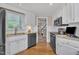 Bright kitchen featuring white cabinets, granite countertops, and stainless steel appliances at 7601 Wellesley N Park, Raleigh, NC 27615