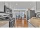 Open-concept kitchen and dining area with stainless steel appliances and natural light at 7601 Wellesley N Park, Raleigh, NC 27615