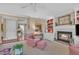 Inviting living room featuring a fireplace, a ceiling fan, and carpeted floors at 7601 Wellesley N Park, Raleigh, NC 27615
