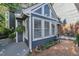 Cozy patio area with a small table, chairs, potted plants, and view of the house at 7601 Wellesley N Park, Raleigh, NC 27615
