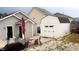 Backyard featuring a patio set, outbuilding, and well-maintained landscaping at 764 Grove Creek Ln, Raleigh, NC 27610
