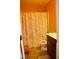 Small full bathroom with a vanity, toilet, and tub with marble-patterned shower curtain at 764 Grove Creek Ln, Raleigh, NC 27610