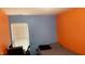 Bedroom with contrasting blue and orange walls and a window with white blinds at 764 Grove Creek Ln, Raleigh, NC 27610
