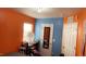 Bedroom with blue and orange walls, and cluttered desk at 764 Grove Creek Ln, Raleigh, NC 27610