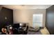 Bedroom with black and white walls and window with blinds, plus desk with computer at 764 Grove Creek Ln, Raleigh, NC 27610