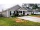 Charming single-story home featuring a welcoming front porch and a well-maintained landscaped yard at 764 Grove Creek Ln, Raleigh, NC 27610