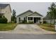 Charming single-story home with a concrete driveway and cozy front porch in a residential neighborhood at 764 Grove Creek Ln, Raleigh, NC 27610