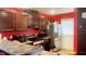 Kitchen with red walls, stainless steel appliances, and wood cabinets at 764 Grove Creek Ln, Raleigh, NC 27610