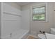 Tiled bathtub with shower combination with white subway tile and a window at 780 Indian Trail Village, Burlington, NC 27217