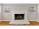 Fireplace in living room with hardwood flooring and natural light from the surrounding windows at 780 Indian Trail Village, Burlington, NC 27217
