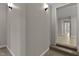 Hallway featuring neutral paint, board and batten accent wall and access to living area and bedrooms at 780 Indian Trail Village, Burlington, NC 27217
