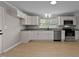 Modern kitchen with white cabinets, stainless steel appliances, and granite countertops at 780 Indian Trail Village, Burlington, NC 27217