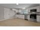 Modern kitchen with white cabinets, stainless steel appliances, and granite countertops at 780 Indian Trail Village, Burlington, NC 27217