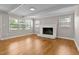 Spacious living room with a decorative fireplace, hardwood floors, and natural lighting at 780 Indian Trail Village, Burlington, NC 27217