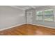 Bright living room with hardwood floors, gray walls, and natural light from the windows at 780 Indian Trail Village, Burlington, NC 27217