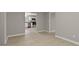 Open concept living room with wood-look floors, and view to updated kitchen at 780 Indian Trail Village, Burlington, NC 27217