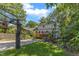 Backyard with basketball court and treehouse, complemented by green grass and trampoline at 821 Onslow St, Durham, NC 27705
