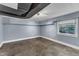 Basement with stone tile flooring, painted cinder block walls, and a window with natural light at 821 Onslow St, Durham, NC 27705
