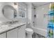 Bathroom featuring subway tile in shower, round mirror, and white vanity with marble countertop at 821 Onslow St, Durham, NC 27705